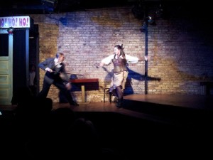 Kevin as Scrooge, swash-buckling with the Ghost of Christmas Present.
